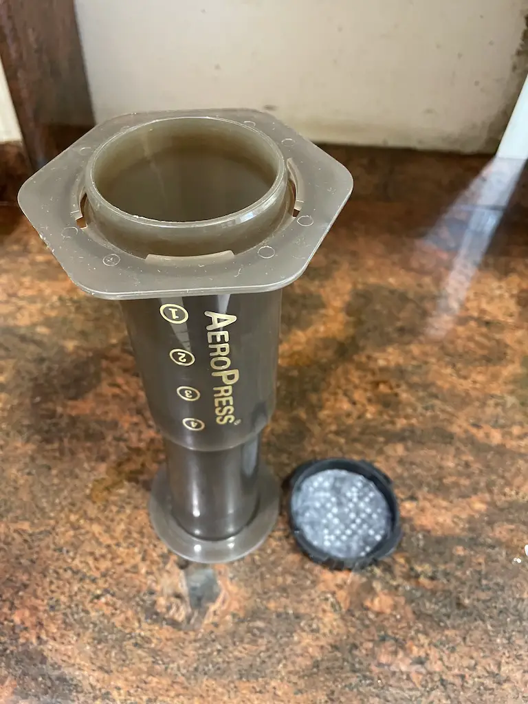 An Aeropress coffee maker with a filter sitting on top of it, perfect for brewing delicious iced coffee using a special recipe.